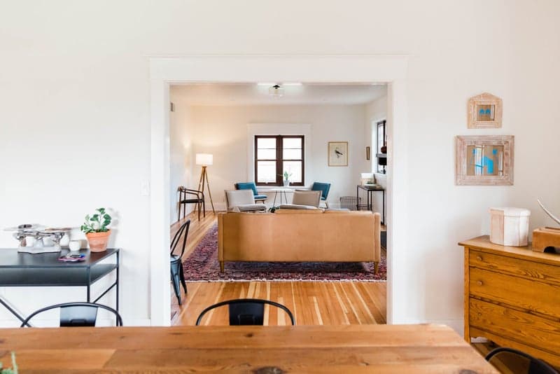 Dining room opening onto a living room with oak floors